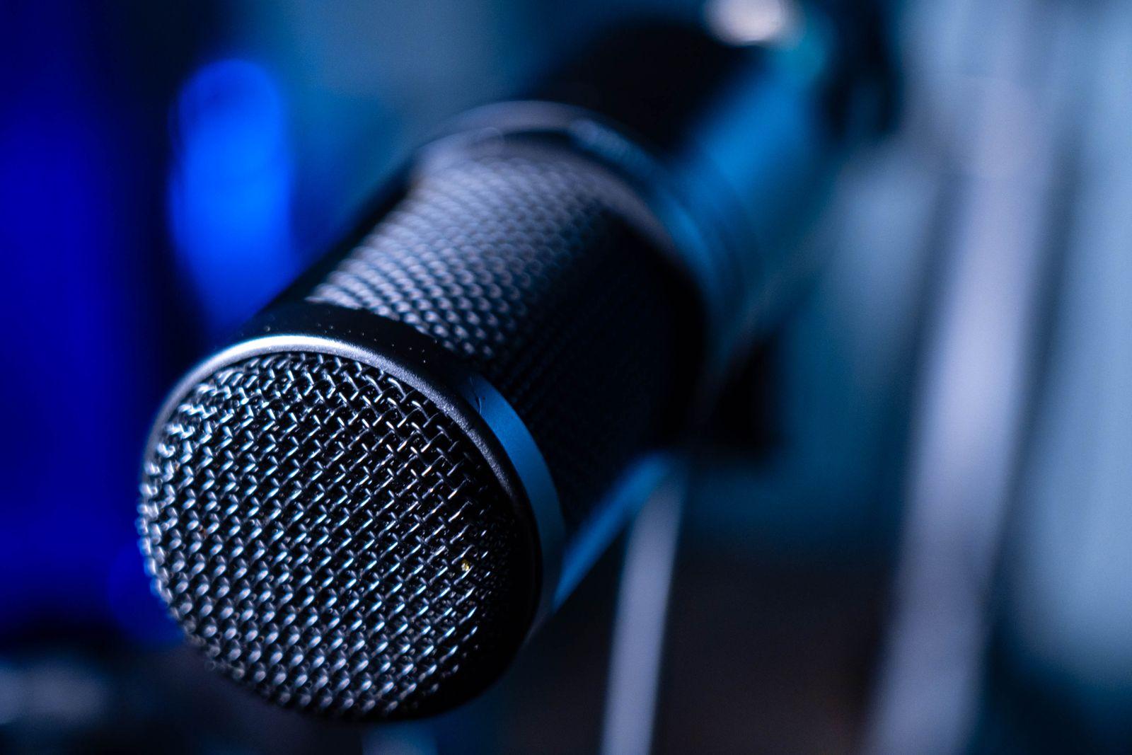 Close-up of a studio microphone under blue light