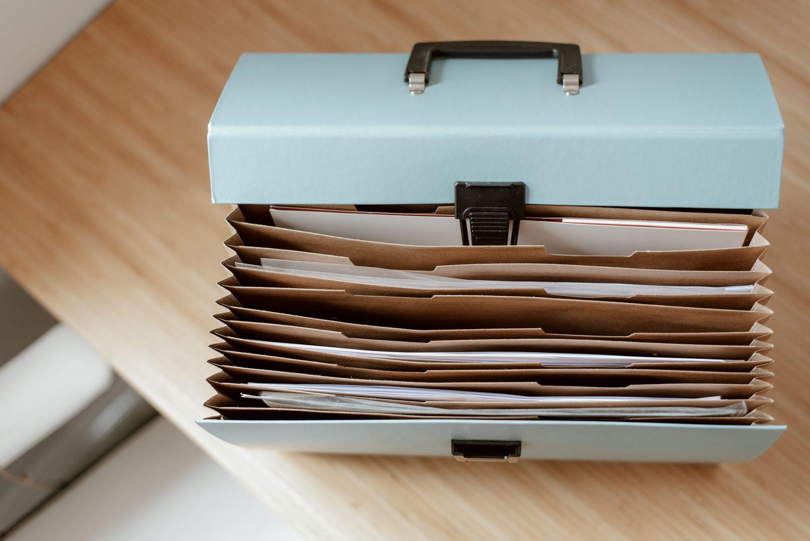 Accordion file box full of folders on a desk