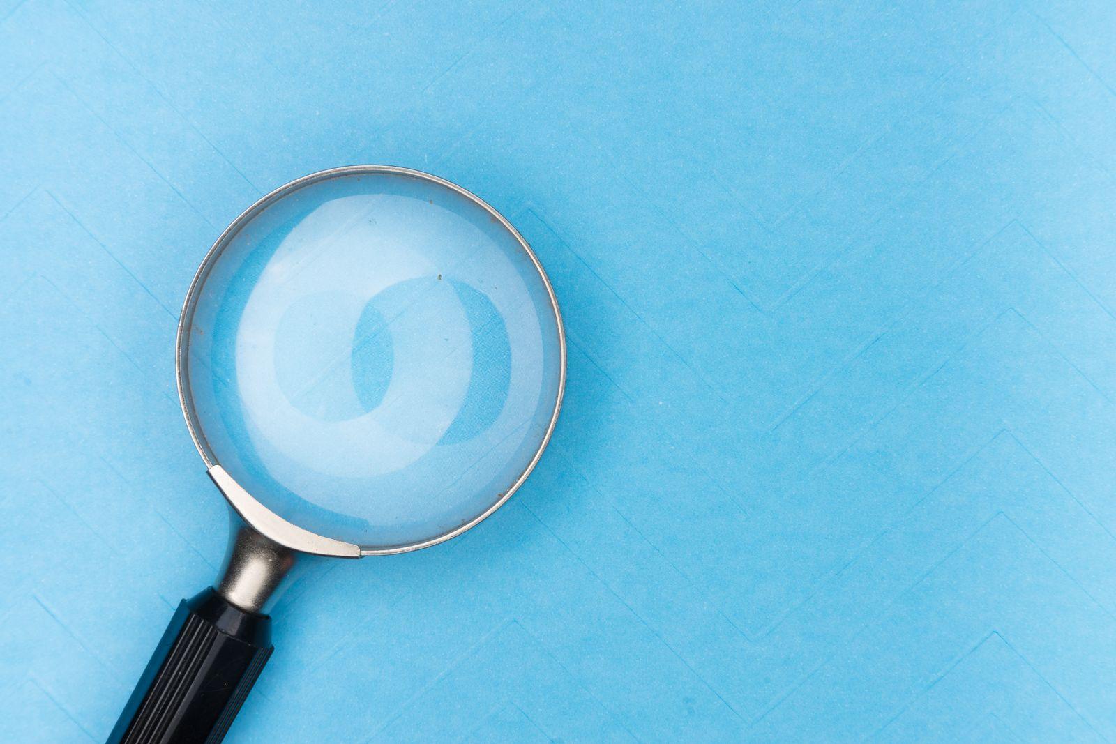Magnifying glass on a light blue background