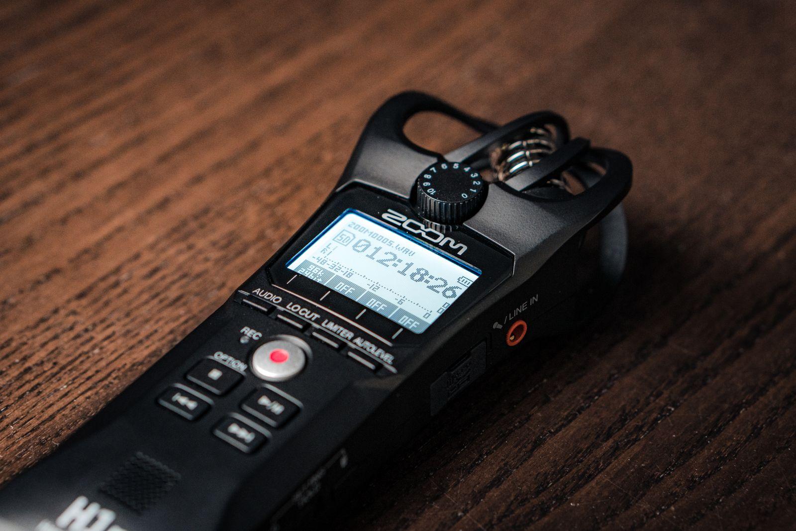 Handheld audio recorder on a wooden table