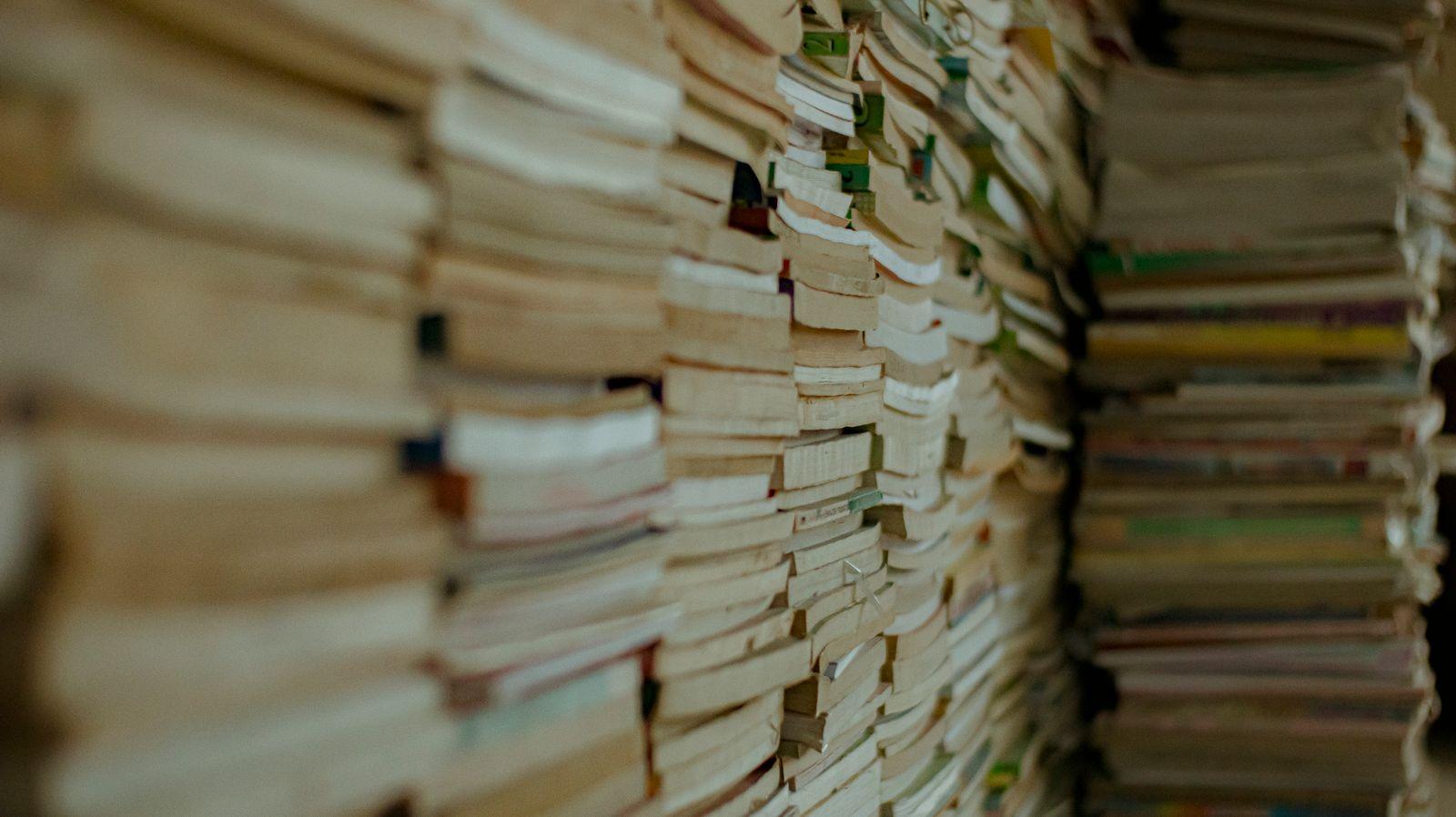 Tall stacks of old magazines and books