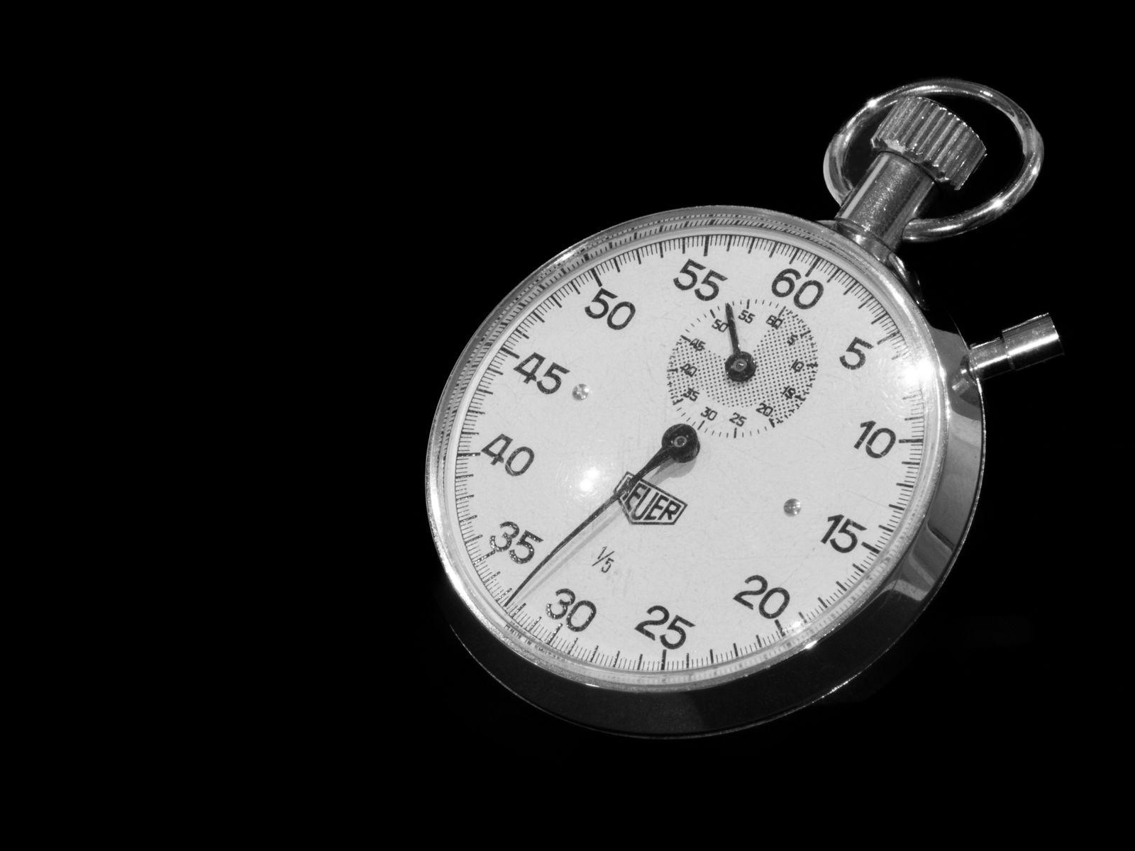 Silver mechanical stopwatch on a black background