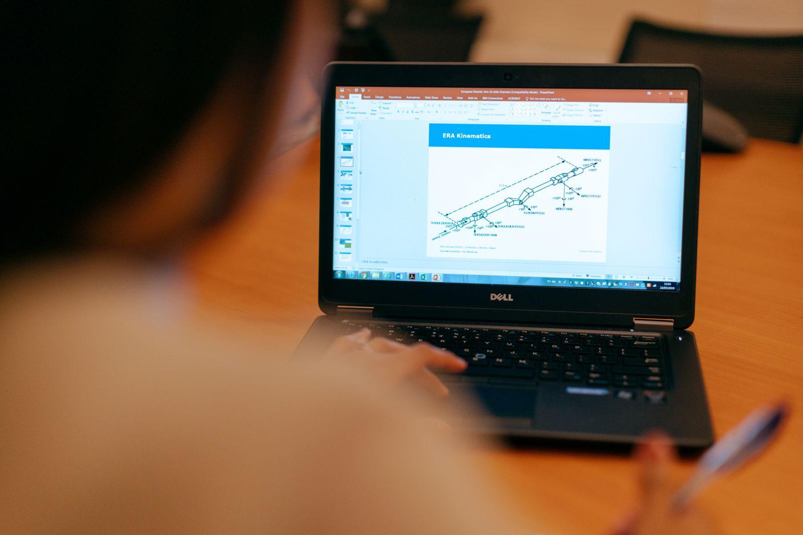 Person working on a laptop with a diagram on the screen